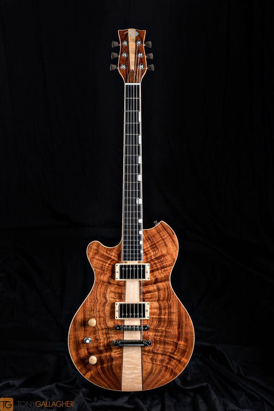 Esparza #0622.  Lefty.  Koa top and Honduran mahogany  slab body and neck.  Ebony FB bound w/pearl blocks.  Sold